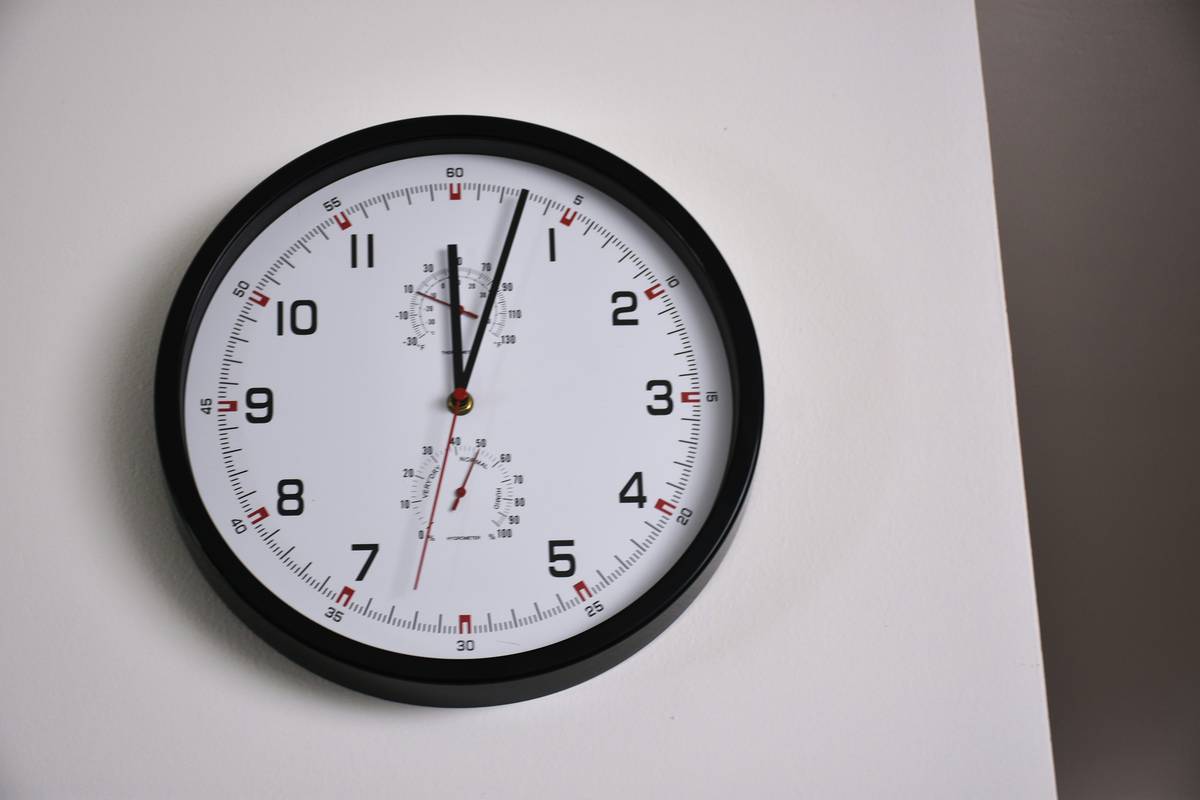 elegant analog timekeeping wall clock living room decor on neutral textured wall