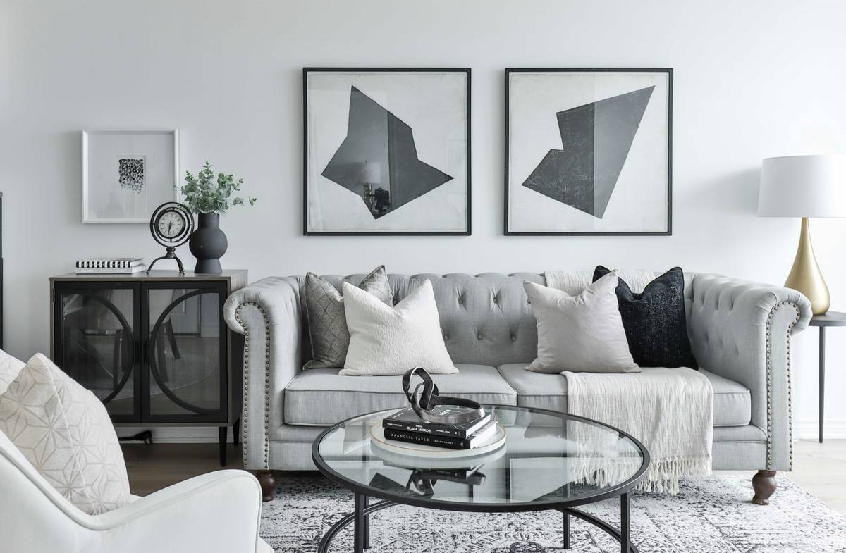 Apple wall clock home decor featuring a minimalist white round clock with black hands mounted on a light gray living room wall